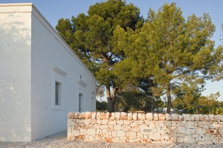 the restored stone structure and dry-stone wall